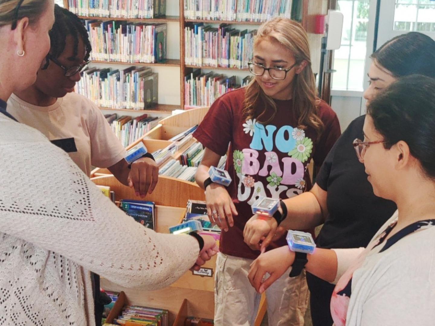 a group of people in a library playing ztag - gunless laser tag.